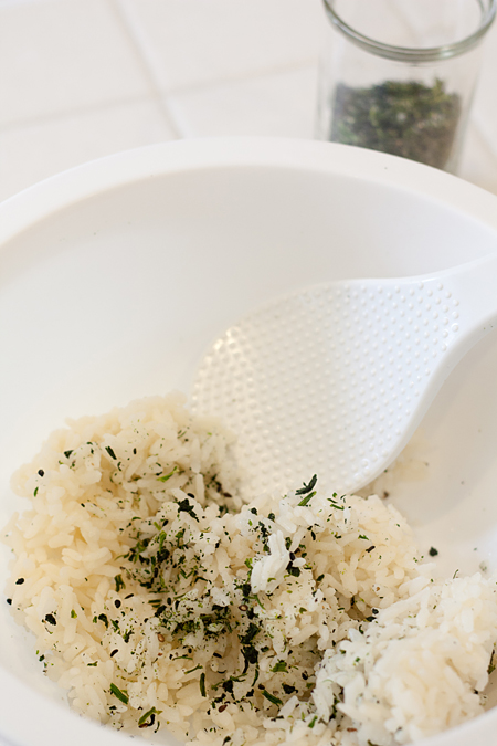 Folding dau miu furikake into steamed rice