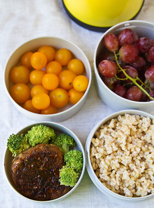 Mr. Bento filled with Vegetarian burger with brown rice, fresh fruit, and veggies