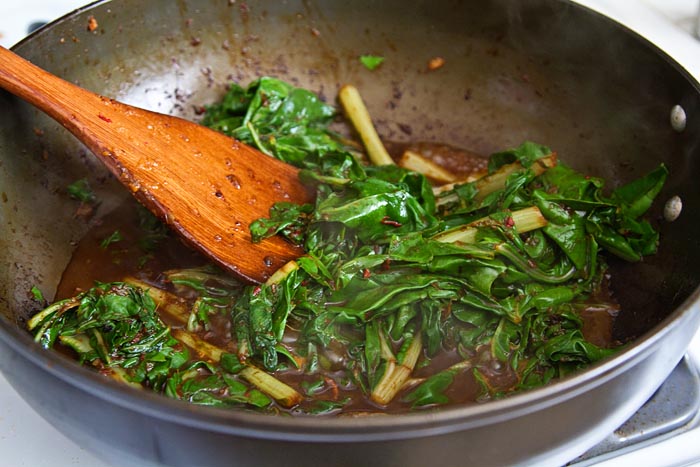 Making stir-fried Asian greens