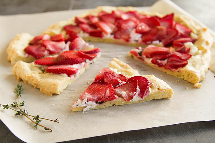 A slice of strawberry chevre flatbread pizza