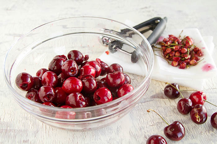 Pitting fresh summer cherries