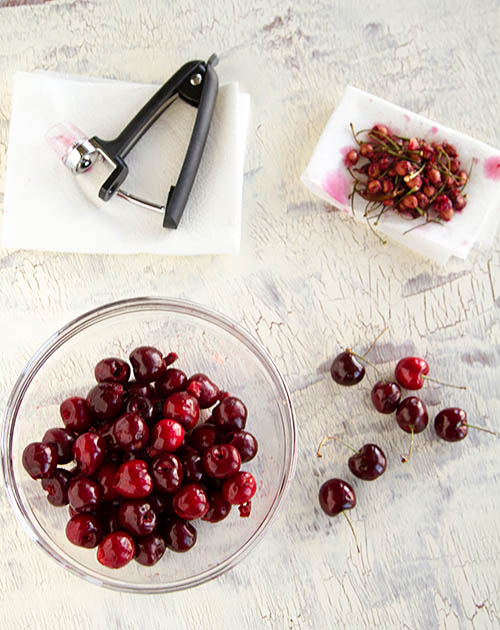 Pitting fresh summer cherries