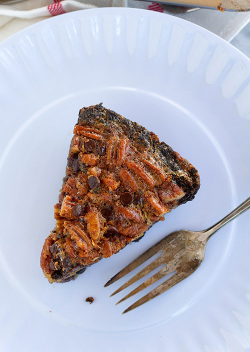 A slice of chocolate chip pecan brownie pie