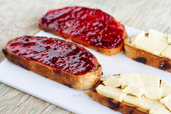 Making grilled cheese sandwiches with jam