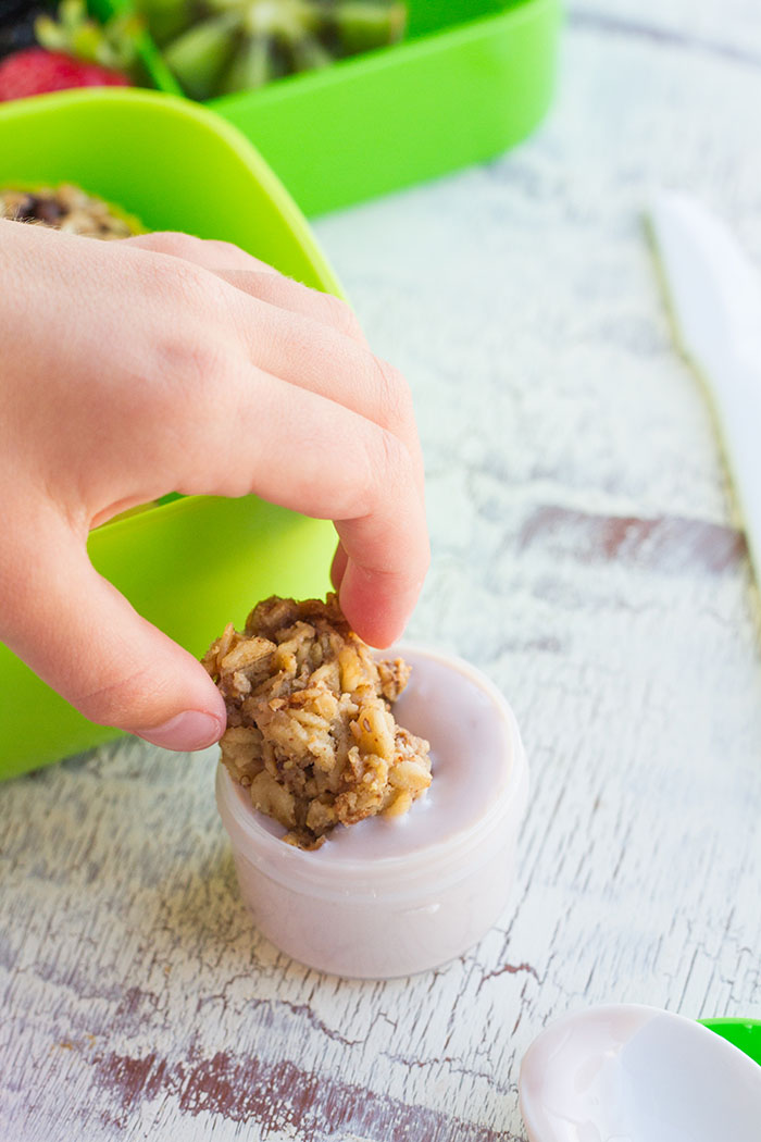 Dipping a Baked Granola Oatmeal Cup into yogrut