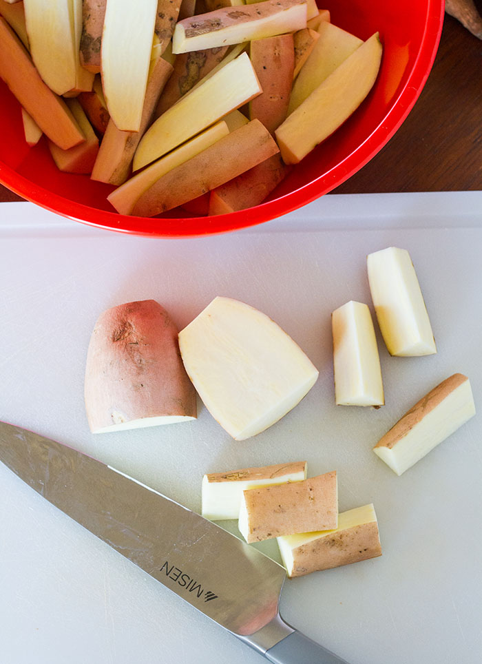 Cutting sweet potatoes into wedges