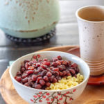 A bowl of ozenzai, a Japanese sweet red bean soup dessert, with cooked millet.