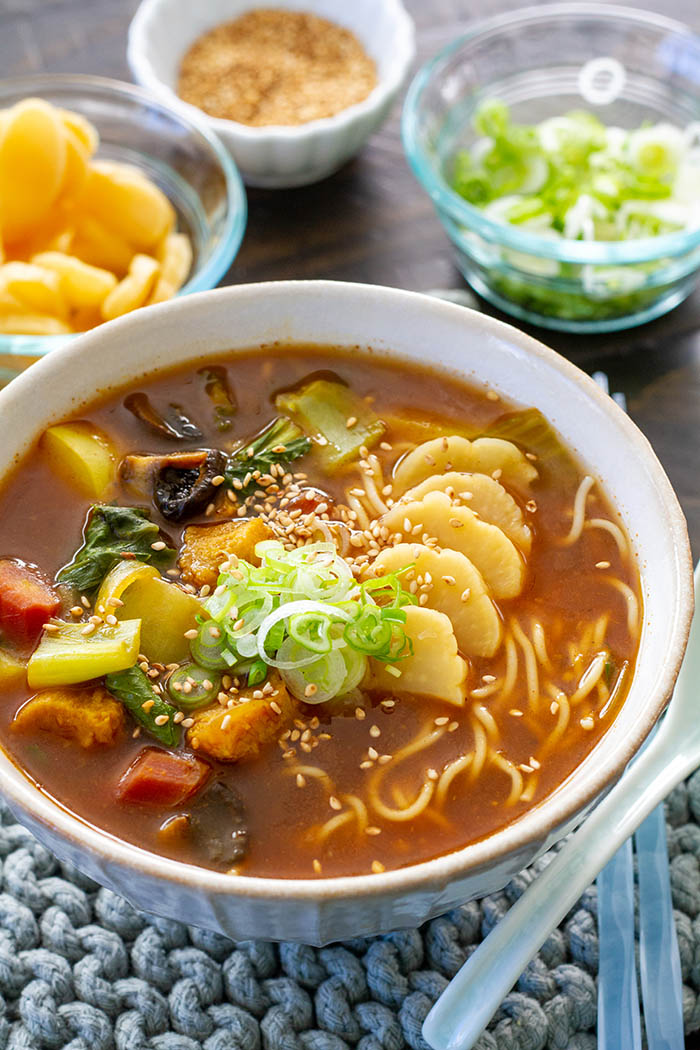 bowl of curry ramen and assorted toppings