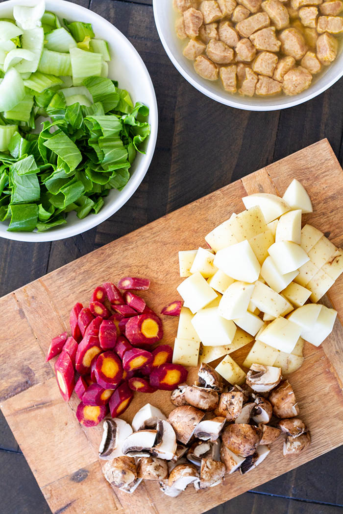 prepped ingredients for curry ramen: baby bok choy, soy curls, carrot, potato, crimini mushrooms